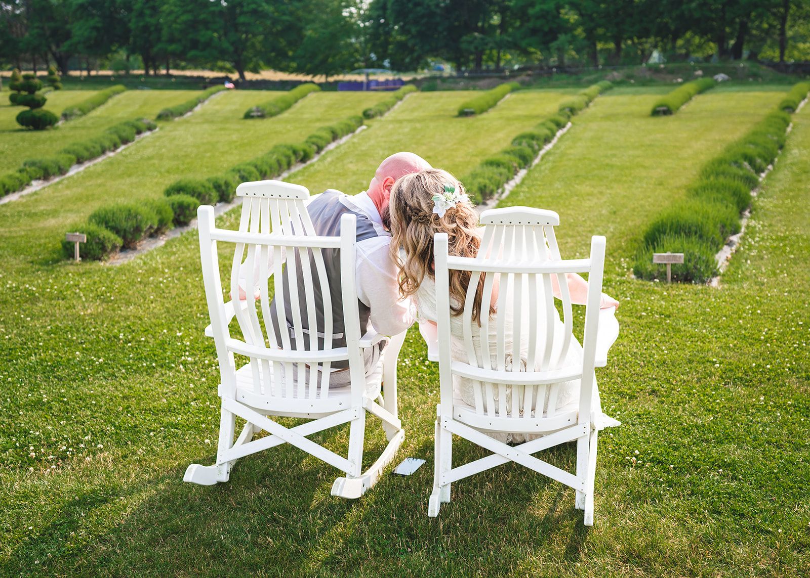 A couple in white rocking chairs overlooking the lavender field