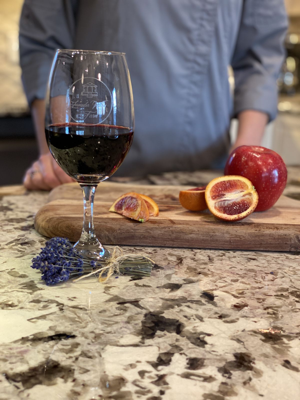 A glass of red wine with lavender and blood orange