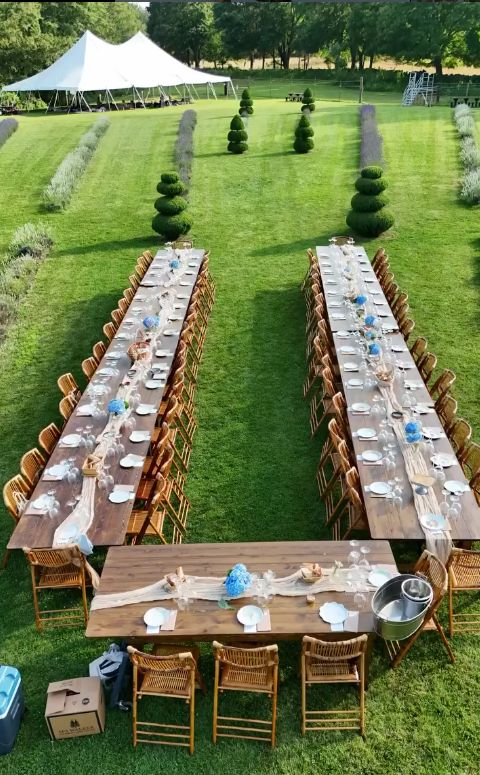 Long banquet tables set on the lawn at Lavender Waves Farm